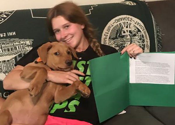 Young woman with her Emotional Support Dog and her ESA Letter